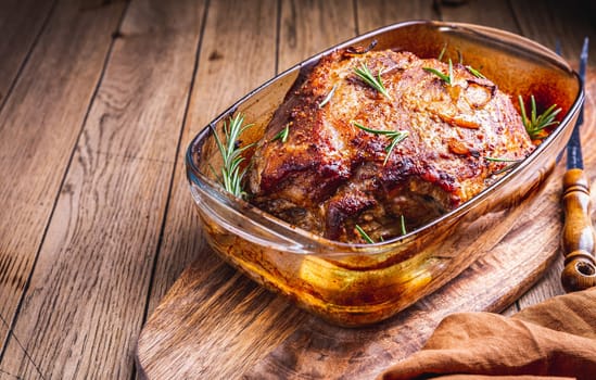 Roasted pork meat with potatoes, rosemary and beer sauce in casserole