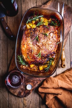 Roasted pork meat with potatoes, rosemary and beer sauce in casserole