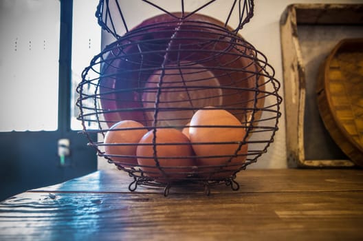Old rusty wire egg cup. Country style background. Selective focus