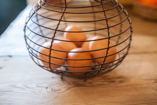 Old rusty wire egg cup. Country style background. Focus on wire