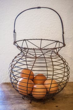 Old rusty wire egg cup. Country style background. Focus on wire