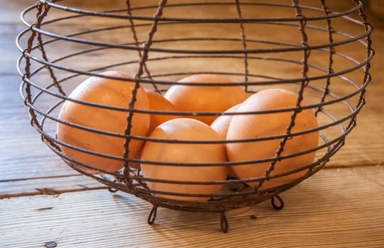 Old rusty wire egg cup. Country style background. Focus on wire