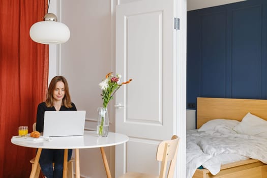 Woman working remotely from home. Freelancer or digital nomad everyday routine.