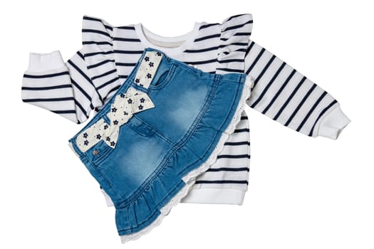 A black and white striped sweater or pullover with a heart and a sexy short blue denim skirt with a white fabric belt with flowers and bow isolated. Clipping path.
