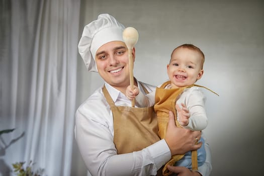 A family enjoys a fun cooking session, playfully covered in flour while engaging with their little ones in a warm kitchen. Father and son having fun