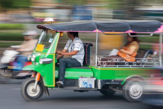 Traditional tuk-tuk from Bangkok, Thailand, in motion blur