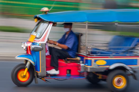Traditional tuk-tuk from Bangkok, Thailand, in motion blur