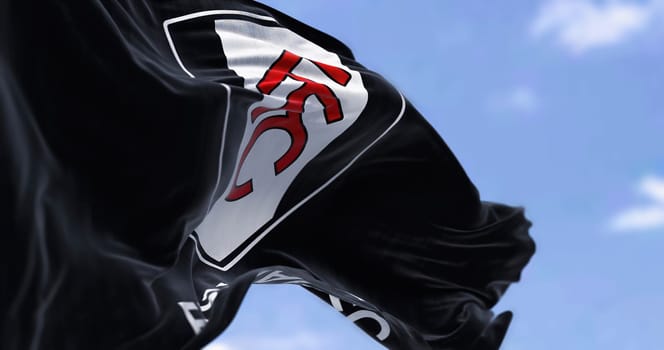 London, UK, jan 2023: flag of Fulham Football Club waving. Professional Football club based in London. English Premier League. Fluttering fabric. Selective focus. Realistic 3d illustration