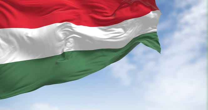 The national flag of Hungary fluttering in the wind on a clear day. Horizontal striped flag of red, white and green. Fluttering fabric. Realistic 3D illustration