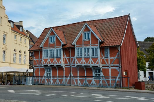 Red half-timbered house on a street in the historic Hanseatic city of Wismar, on the Baltic Sea coast of Mecklenburg-West Pomerania in Germany