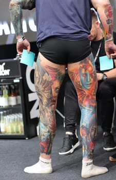Krakow, Poland - June 12, 2022: Unidentified participant during the contest for the best tattoo at the 15th Tattoofest Convention in Cracow. One of the most prestigious tattoo festivals.