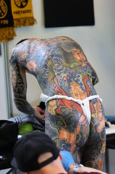 Krakow, Poland -  June 11, 2022: Unidentified  participant at 15th Tattoofest Convention in Cracow. One of the most prestigious tattoo festivals. Tattoo artist at work.