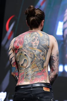 Krakow, Poland - June 11, 2022: Unidentified participant during the contest for the best tattoo at the 15th Tattoofest Convention in Cracow. One of the most prestigious tattoo festivals.