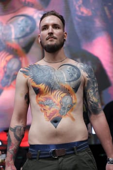 Krakow, Poland - June 12, 2022: Unidentified participant during the contest for the best tattoo at the 15th Tattoofest Convention in Cracow. One of the most prestigious tattoo festivals.