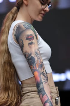 Krakow, Poland - June 12, 2022: Unidentified participant during the contest for the best tattoo at the 15th Tattoofest Convention in Cracow. One of the most prestigious tattoo festivals.