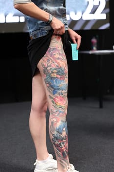 Krakow, Poland - June 12, 2022: Unidentified participant during the contest for the best tattoo at the 15th Tattoofest Convention in Cracow. One of the most prestigious tattoo festivals.
