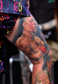 Krakow, Poland - June 12, 2022: Unidentified participant during the contest for the best tattoo at the 15th Tattoofest Convention in Cracow. One of the most prestigious tattoo festivals.