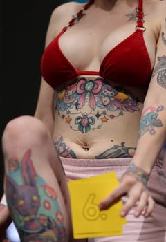 Krakow, Poland - June 11, 2022: Unidentified participant during the contest for the best tattoo at the 15th Tattoofest Convention in Cracow. One of the most prestigious tattoo festivals.