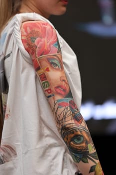 Krakow, Poland - June 12, 2022: Unidentified participant during the contest for the best tattoo at the 15th Tattoofest Convention in Cracow. One of the most prestigious tattoo festivals.