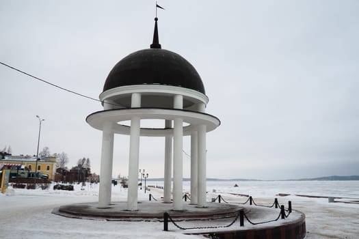Petrozavodsk, Karelia, Russia, January 16, 2023 Arbor-rotunda with a spire on the city embankment of Lake Onega. Classic style architecture. Symbol of the city and venue for wedding ceremonies. Winter