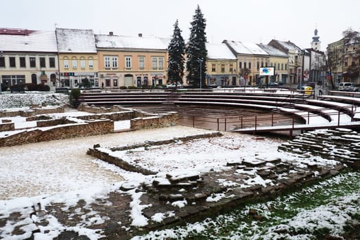 Sremska Mitrovica Serbia 01.27.2023 Snowfall in the city. Zhitni trg historical square. Ancient multi-colored buildings and excavations of Roman times. Weather forecast. Day winter. Cultural heritage