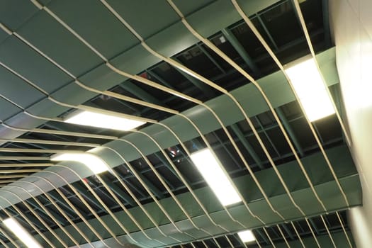 Metal structures under the ceiling. Decorative details of the airport ceiling . Concrete beams, glass lusters and metal elements as public building interior design. Abstract avant-garde architecture