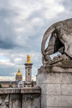 Tail of a Lion Sculpture on Bridge Alexandre III, view to the Military museum, Paris, France