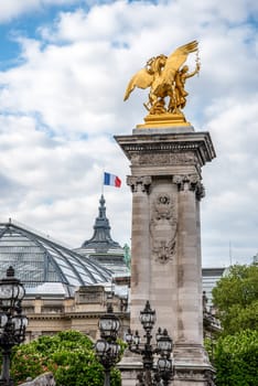 Column at the Bridge Alexandre III, the Grand Palais in the background, Paris, France