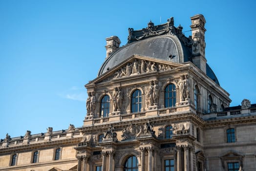 Detail of the left wing facade of Louvre Palace on a sunny summer day in Paris, France