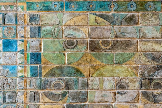Colorful ancient Persian wall frieze in the Louvre museum in Paris, France