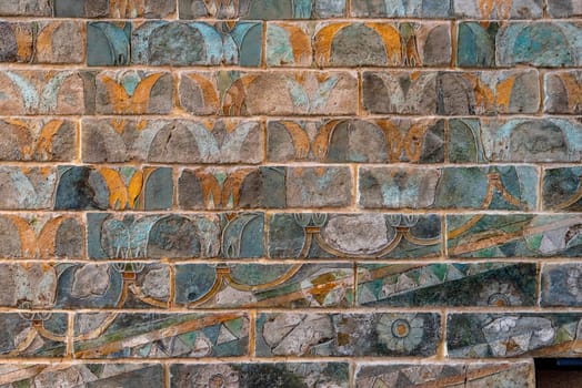 Colorful ancient Persian wall frieze in the Louvre museum in Paris, France