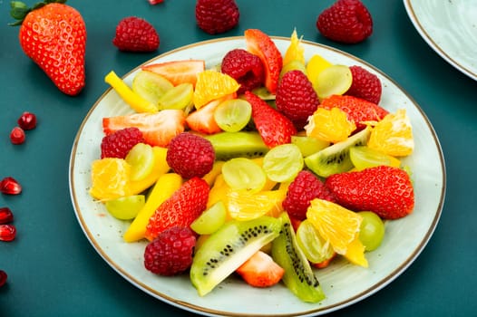 Healthy fresh fruit with mango, juicy citrus, banana and berries in a bowl