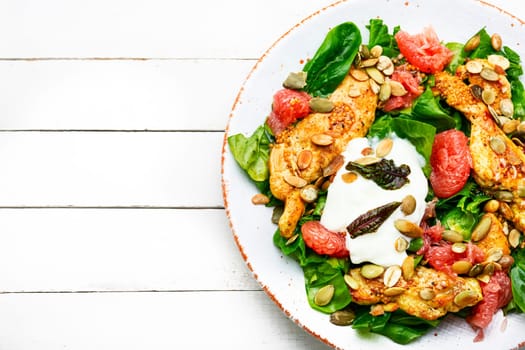 Meat salad with chicken breast, lettuce and citrus fruits. Healthy and detox food concept