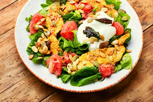 Meat salad with chicken breast, lettuce and citrus fruits. Healthy and detox food concept