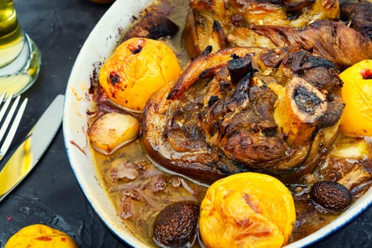Roasted pork knuckle eisbein with cabbage and apples. Pork leg in the oven dish. German food. Octoberfest dinner