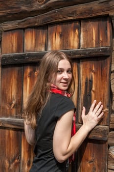The Norway old  wooden church and cemetery.  young girl on the background of old wall