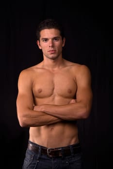 young sensual man on a black background