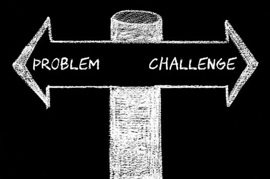 Opposite arrows with Problem versus Challenge. Hand drawing with chalk on blackboard. Choice conceptual image