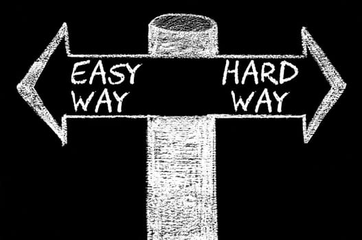 Opposite arrows with Easy Way versus Hard Way. Hand drawing with chalk on blackboard. Choice conceptual image