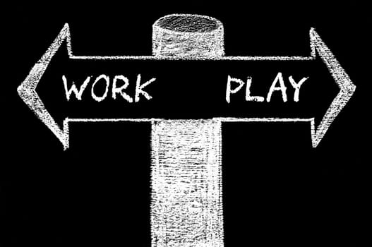 Opposite arrows with Work versus Play. Hand drawing with chalk on blackboard. Choice conceptual image