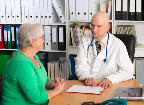 young family doctor in interview with a female senior