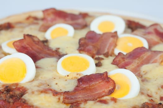 Close-up of a pizza with ham and egg