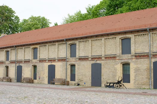 The exterior of the stables of a riding stable.