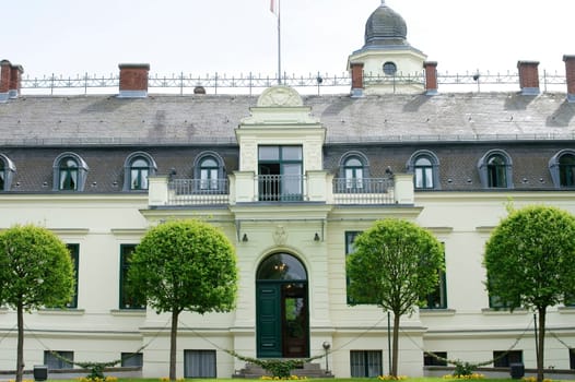 Berlin,Germany – May 05,2015: The front view and the entrance of Britz Castle in Berlin's Neukölln district with a driveway on May 5,2015 in Berlin.