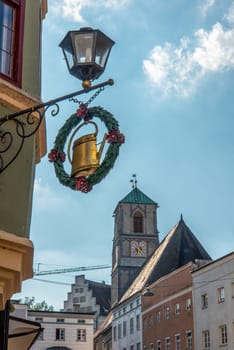 Old historic Shop Sign beneath a Street Lamp in downtown Wasserburg in Bavaria, Germany