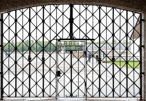 Iconic gate at the entrance to concentration camp Dachau with the scorned inscription -work brings freedom-, Germany