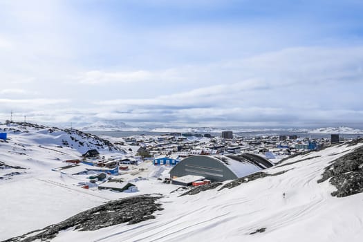 Nuuk city covered in snow with sea and mountains in the background, Greenland