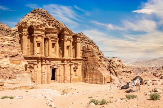 Ad Deir or The Monastery, ancient Nabataean stone carved temple, with donkeys in the foreground, Petra, Jordan
