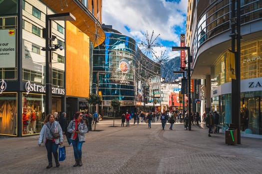 Andorra la Vella, Andorra, Jan 2020 People duty free shopping, street with modern shops and restaurants. Capital city in Pyrenees Mountains