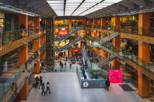 Andorra la Vella, Andorra, Jan 2020 Top view on people shopping in multi floor shopping mall or a gallery in a capital city. Pyrenees Mountains